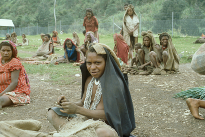 Mendi, Southern Highlands of PNG. Markets are fascinating everywhere. This woman is unravelling a rice bag for the fibre with which she will crochet a traditional string “bilum.”